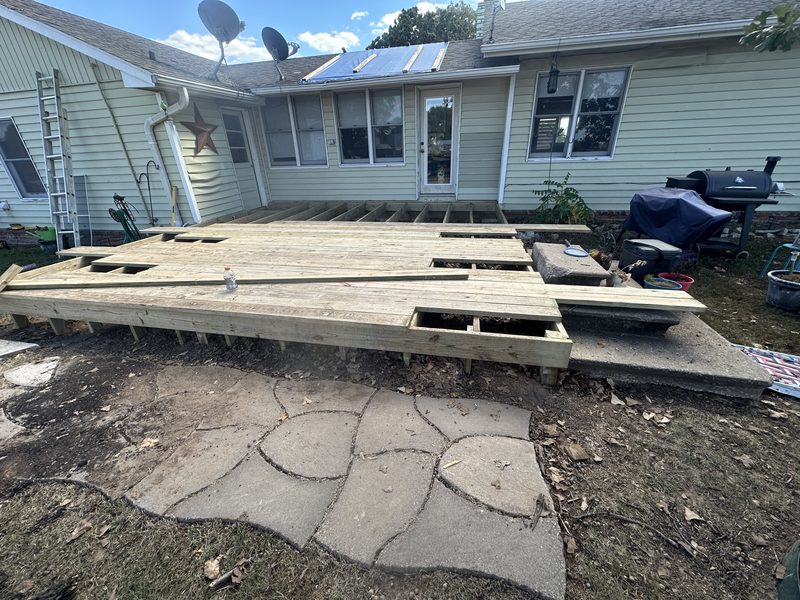 Freshly rebuilt deck frame and new decking installed across the back of the home
